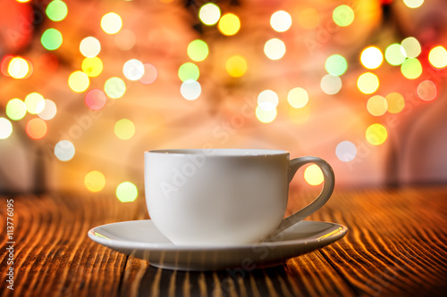 cup of coffee  in   holiday colorful bokeh background