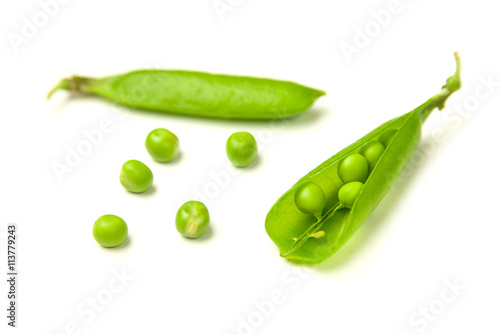 Pea pods and pea seeds on white