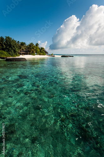 Emerald water pf the Maldivian coral reef near island