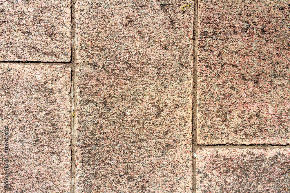 Fototapeta premium Red-tiled floor granite focused from above 