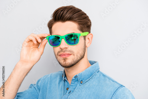  handsome stylish young man holding glasses