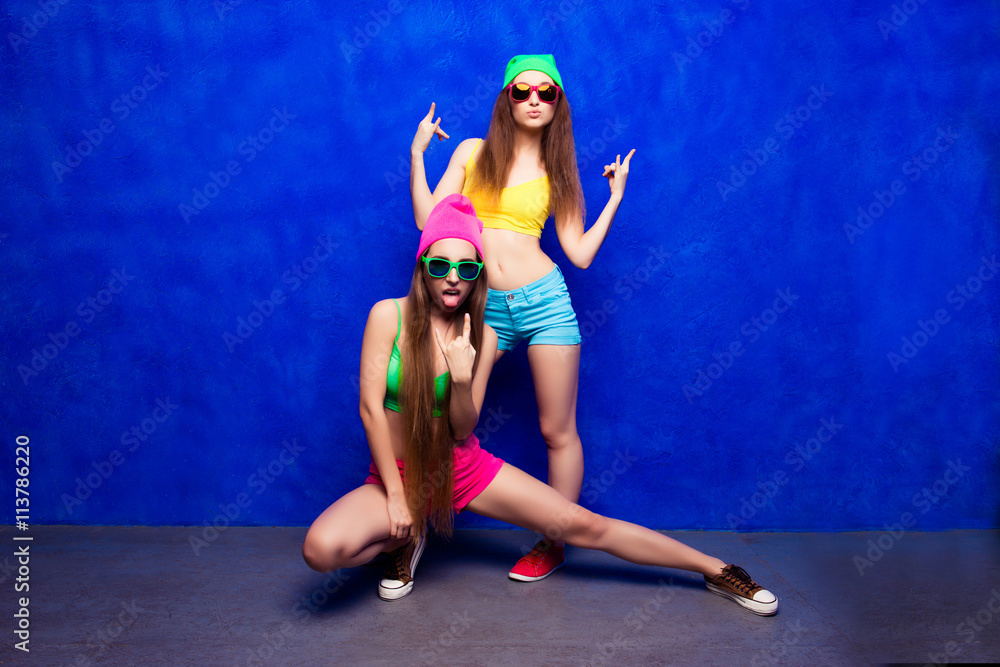 Two sexy hooligans showing fuck on blue background Stock Photo | Adobe Stock