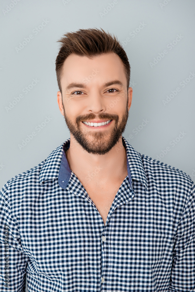 Fototapeta premium Portrait of handsome bearded young man with beaming smile