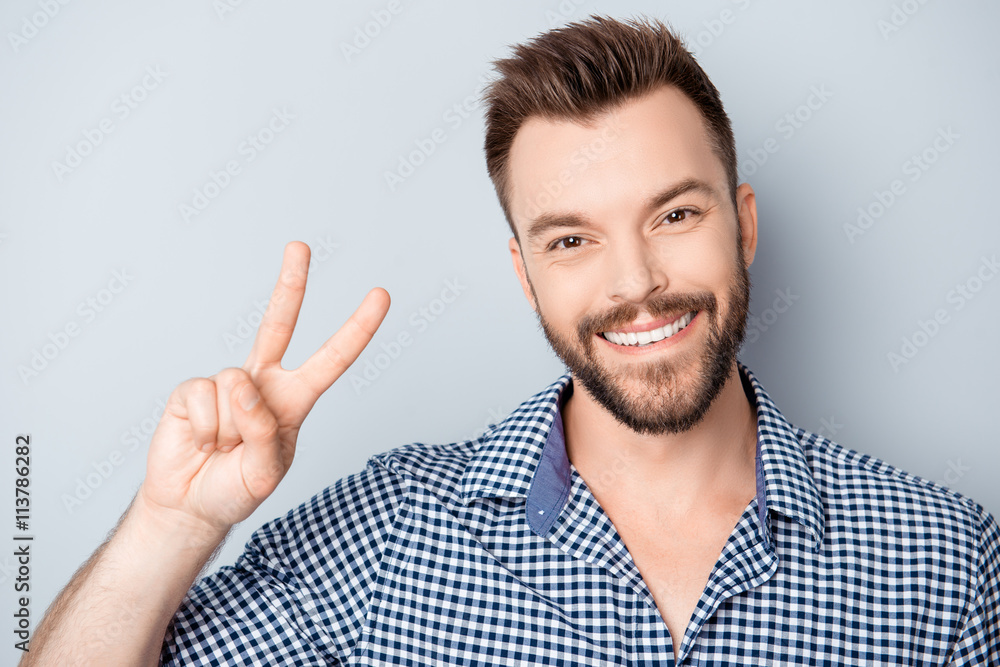 Handsome man with beaming smile showing two fingers Handsome man with beaming smile showing two fingers