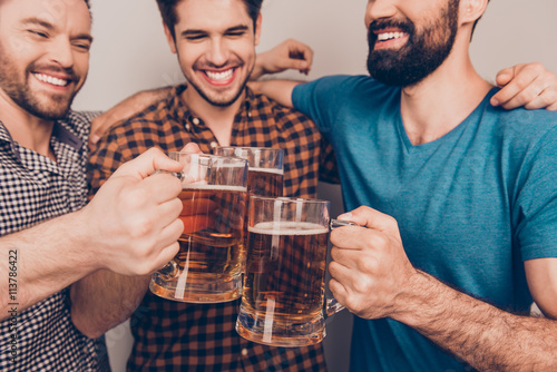 cheers! Close up photo of happy handsome men celebrating victory photo