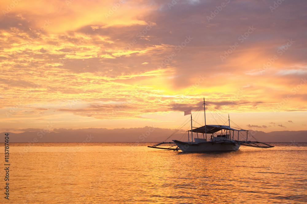 Amazing colorfull sunset at the sea with philippine boat