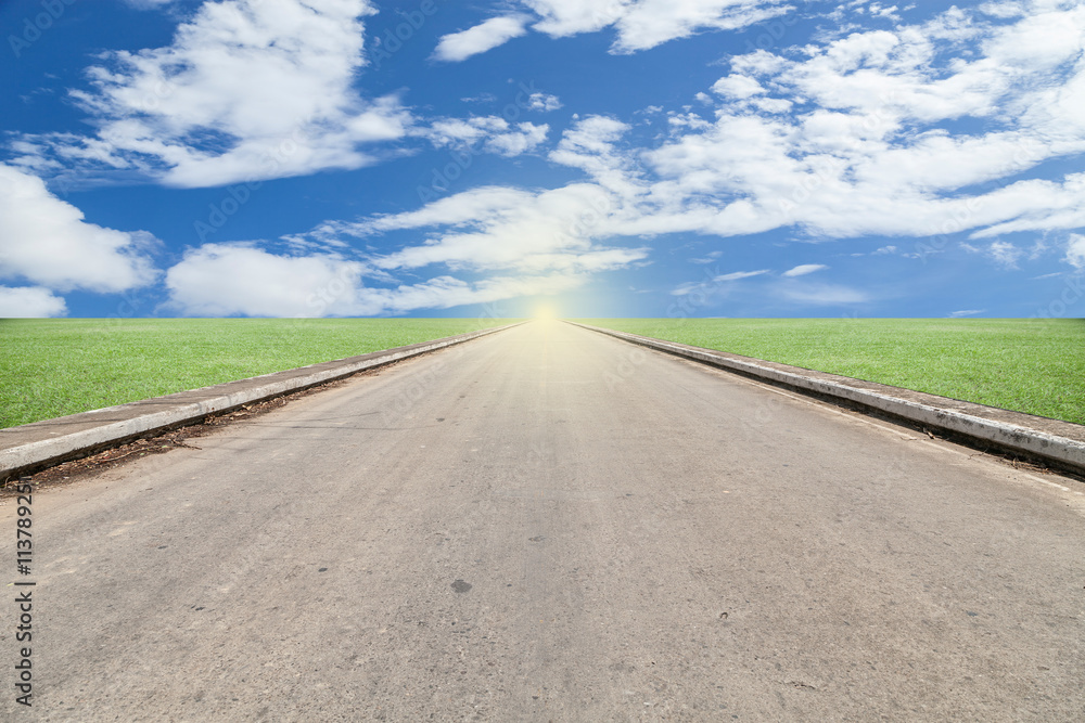 asphalted road with green grass blue sky background. asphalted road with green grass blue sky background.