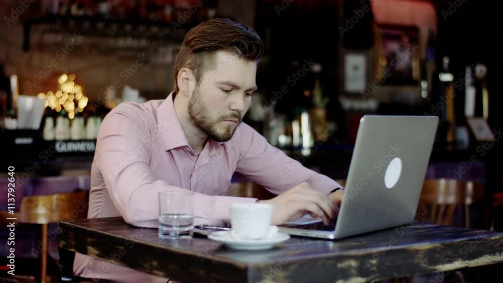 young business man is typing on a laptop young business man is typing on a laptop