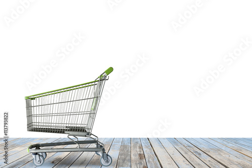 shopping carts on the wooden floor. isolated on white. © panya99