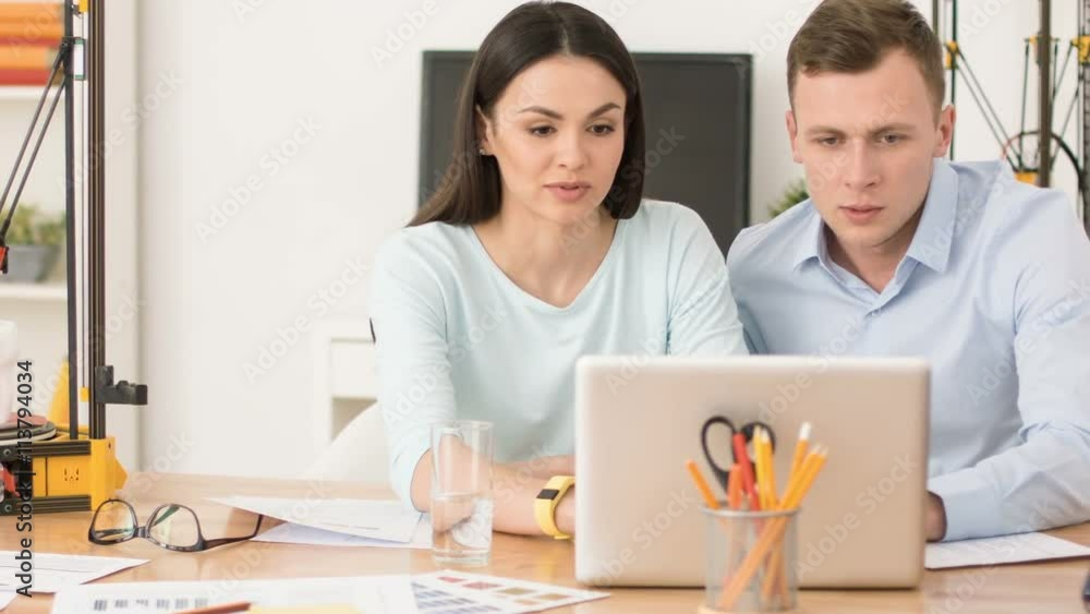 Nice colleague using laptop