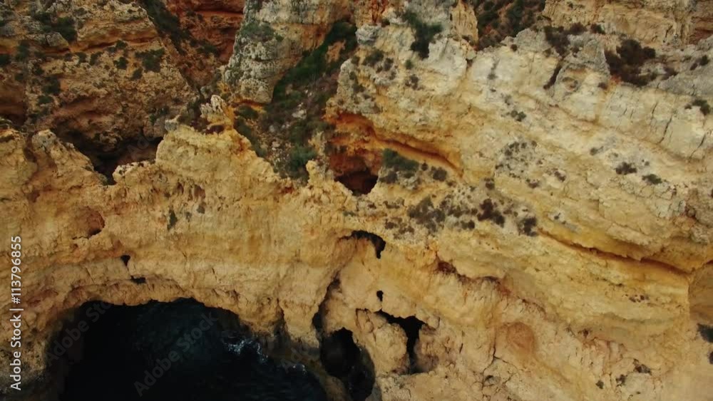 Cliffs in ocean near Ponte Piedade Lighthouse Lagos Portugal aerial view Cliffs in ocean near Ponte Piedade Lighthouse Lagos Portugal aerial view