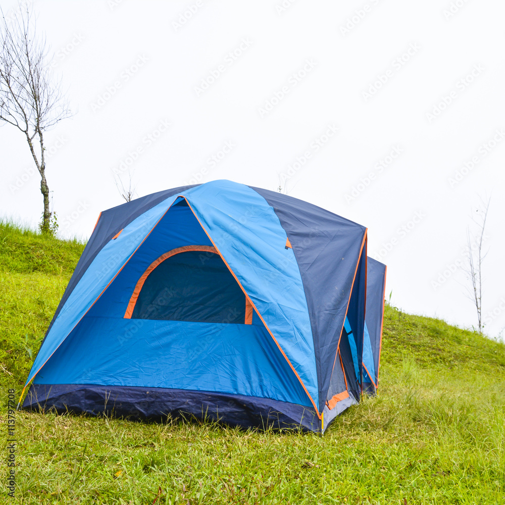 Camping with tent on the grass background
