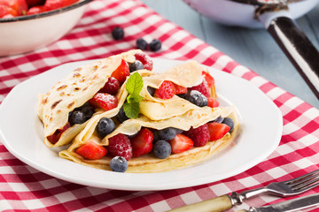 Delicious pancakes with raspberries, blueberries and strawberrie