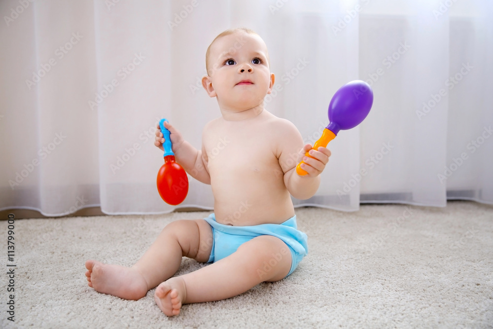 Baby boy playing with toys on the floor Baby boy playing with toys on the floor