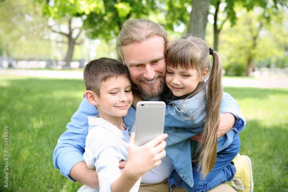Happy family taking selfie in the park Happy family taking selfie in the park