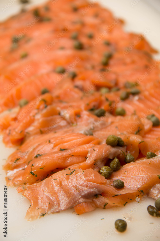 Smoked salmon slide on a plate with parsley Smoked salmon slide on a plate with parsley