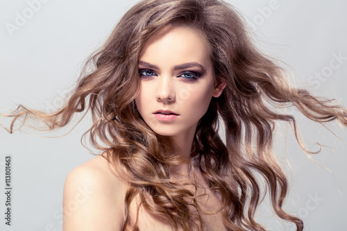 Portrait of young beautiful girl with flying hair. Fashion photo