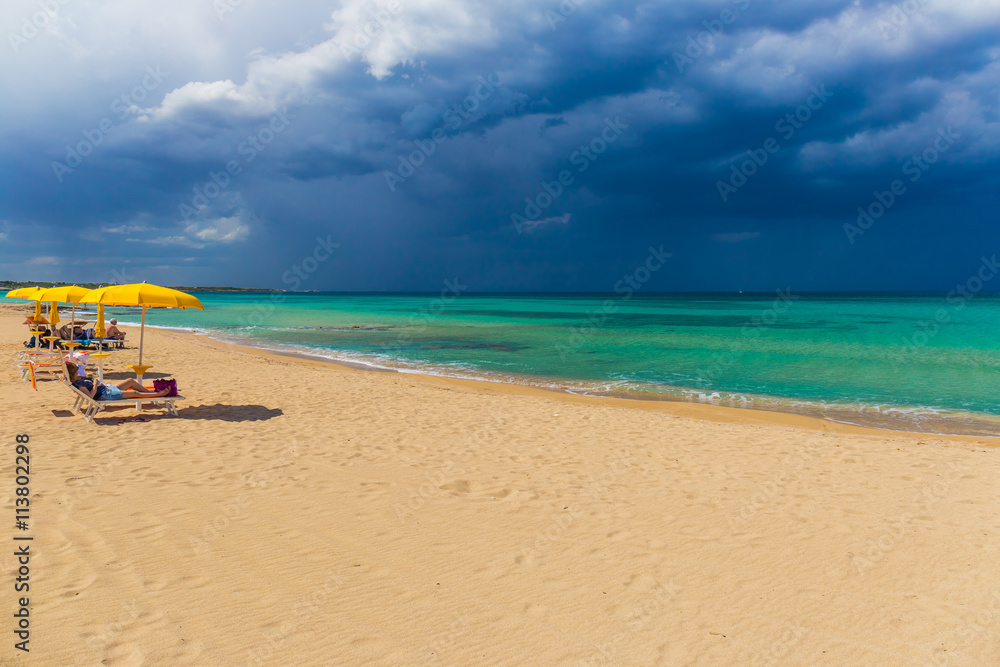 Amazing golden sand beach near Monopolli Capitolo, amazing atmosphere during stormy day, Apulia region, Southern Italy