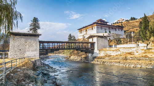 The bridge across the river with traditional bhutan palace, Paro photo