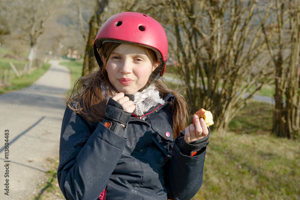 preteen with roller skate helmet, eat an apple preteen with roller skate helmet, eat an apple