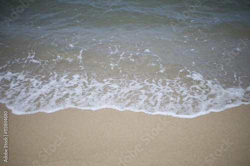 close up of wave of the sea on the sand beach.