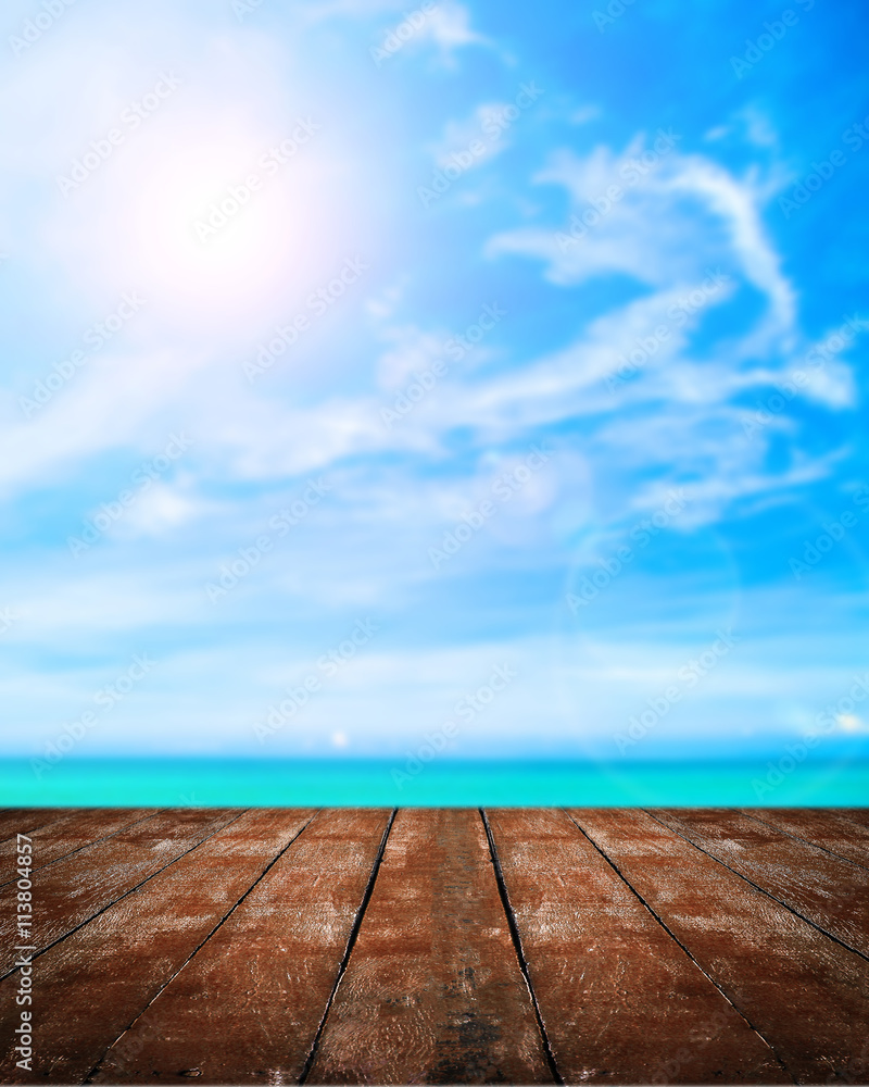 Beautiful beach with wooden plank on blue sky with the sun background. Beautiful beach with wooden plank on blue sky with the sun background.