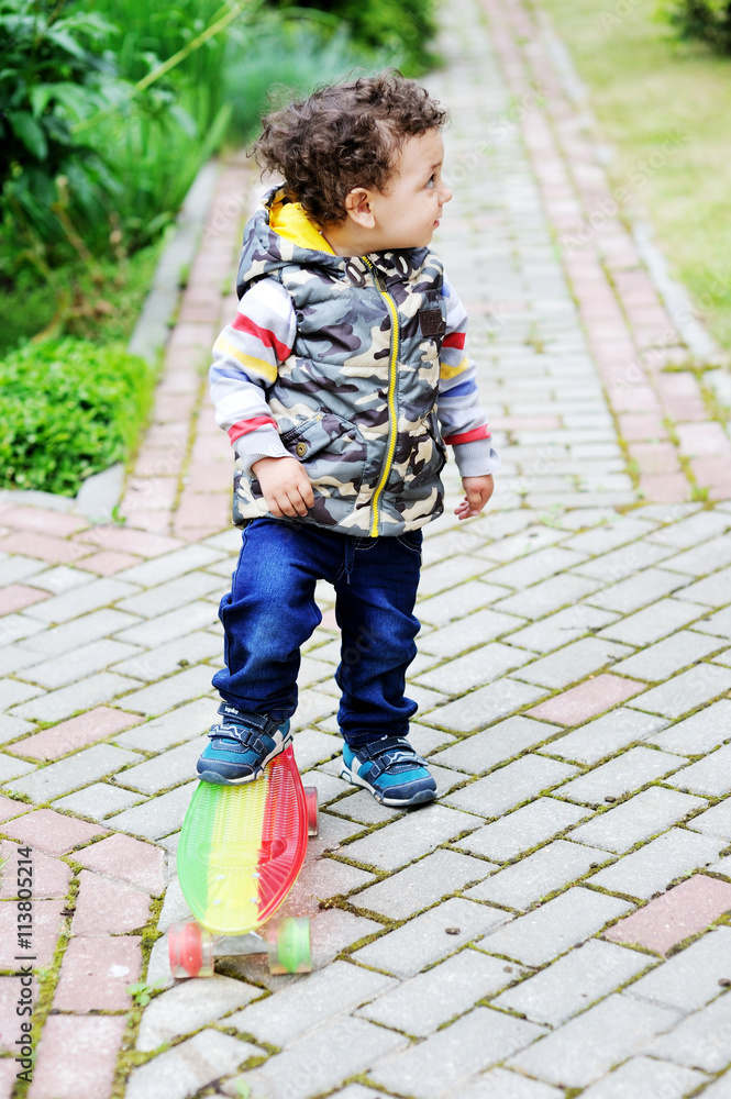 little boy having fun with skateboard outdoors. little boy having fun with skateboard outdoors.