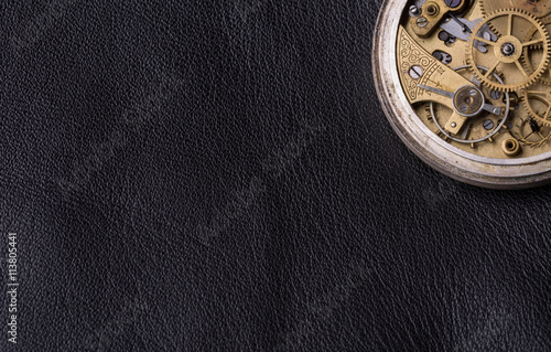 old clock mechanism on black leather background