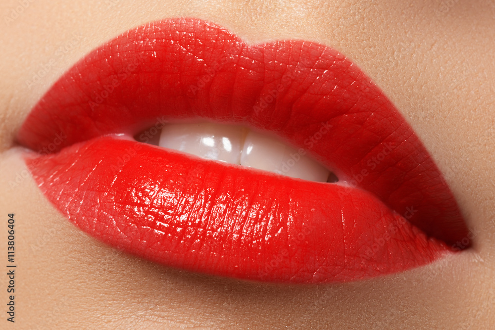 Obraz premium Close-up shot of woman lips with red lipstick. Beautiful perfect lips. Sexy mouth close up. Beautiful wide smile of young fresh woman with full lips