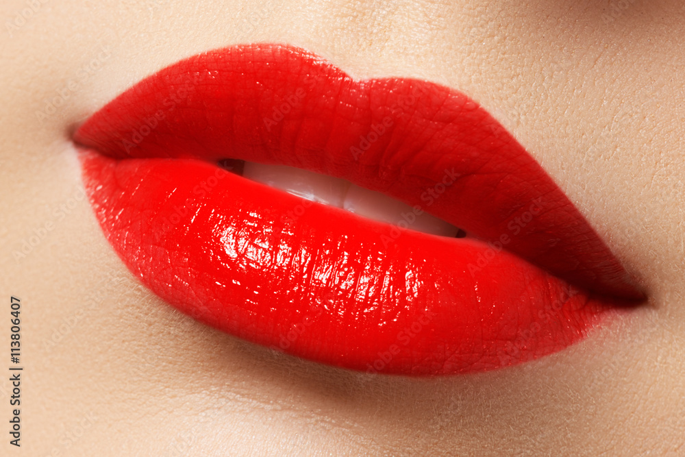 Obraz premium Close-up shot of woman lips with red lipstick. Beautiful perfect lips. Sexy mouth close up. Beautiful wide smile of young fresh woman with full lips