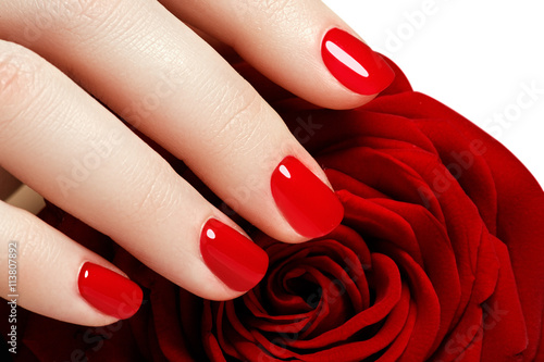 Fototapeta Manicure. Beautiful manicured woman's hands with red nail polish