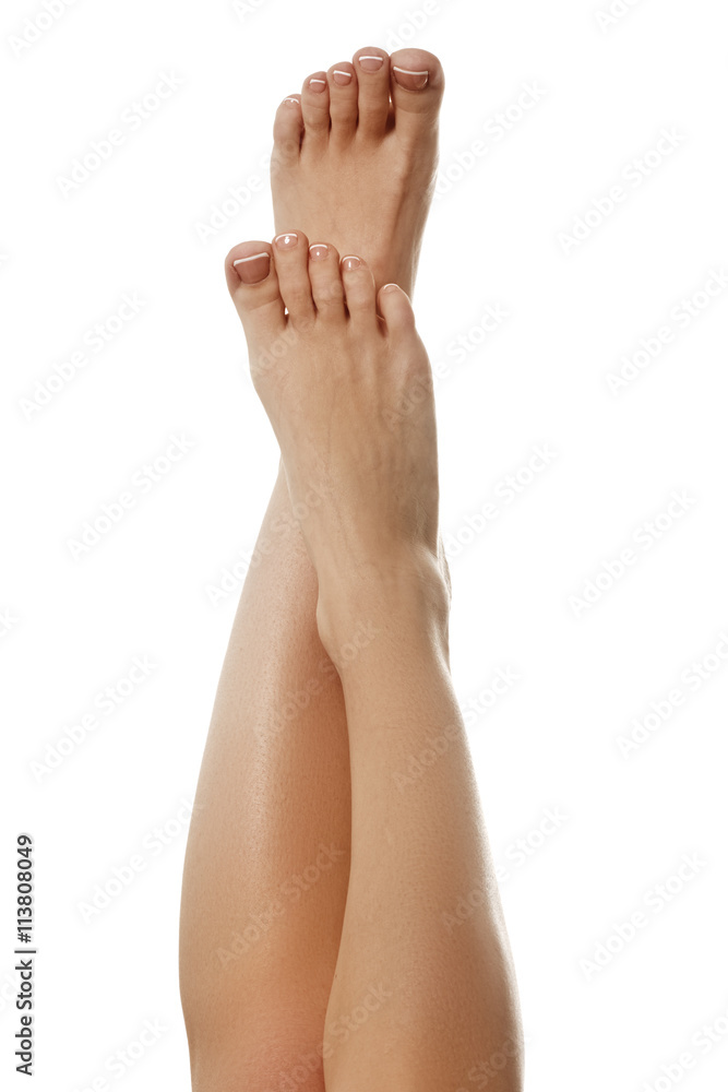 Closeup photo of a female feet with white french pedicure Closeup photo of a female feet with white french pedicure