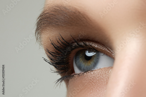 Macro shot of woman's beautiful eye with extremely long eyelashes