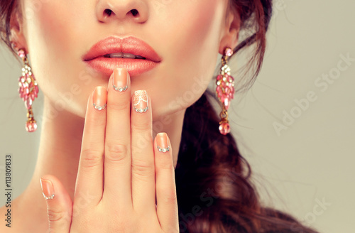 Luxury fashion style, manicure nail , cosmetics and make-up . beige nails with rhinestones .Beauty , skincare , makeup and cosmetics 