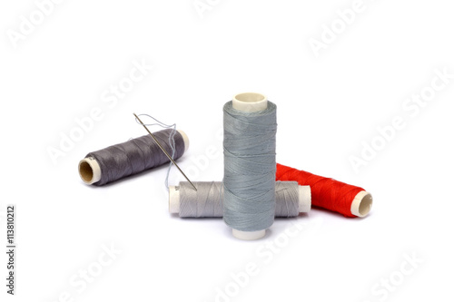 Needle, thimble, scissors, thread isolated on white background