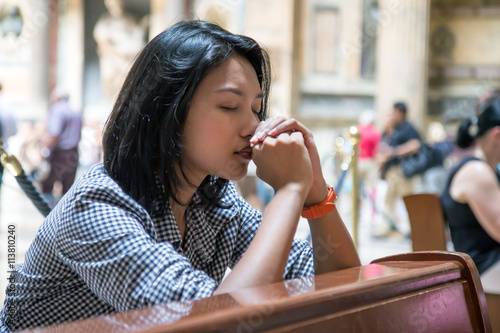 Woman praying in church photo