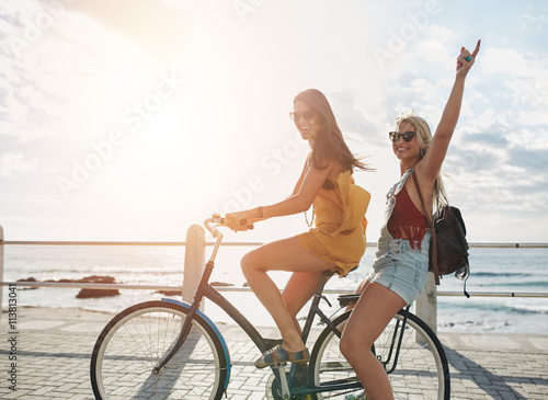 Happy young women enjoying bike ride