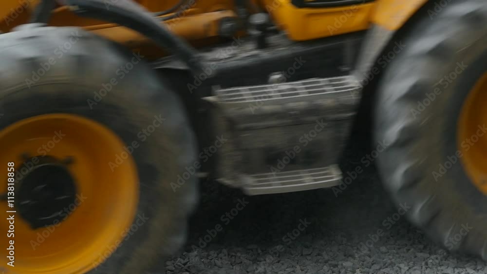 Slow motion shot of the excavator carries gravel in the bucket on road construction Slow motion shot of the excavator carries gravel in the bucket on road construction