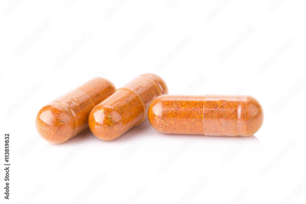 Turmeric powder inside a capsule isolated on white Turmeric powder inside a capsule isolated on white
