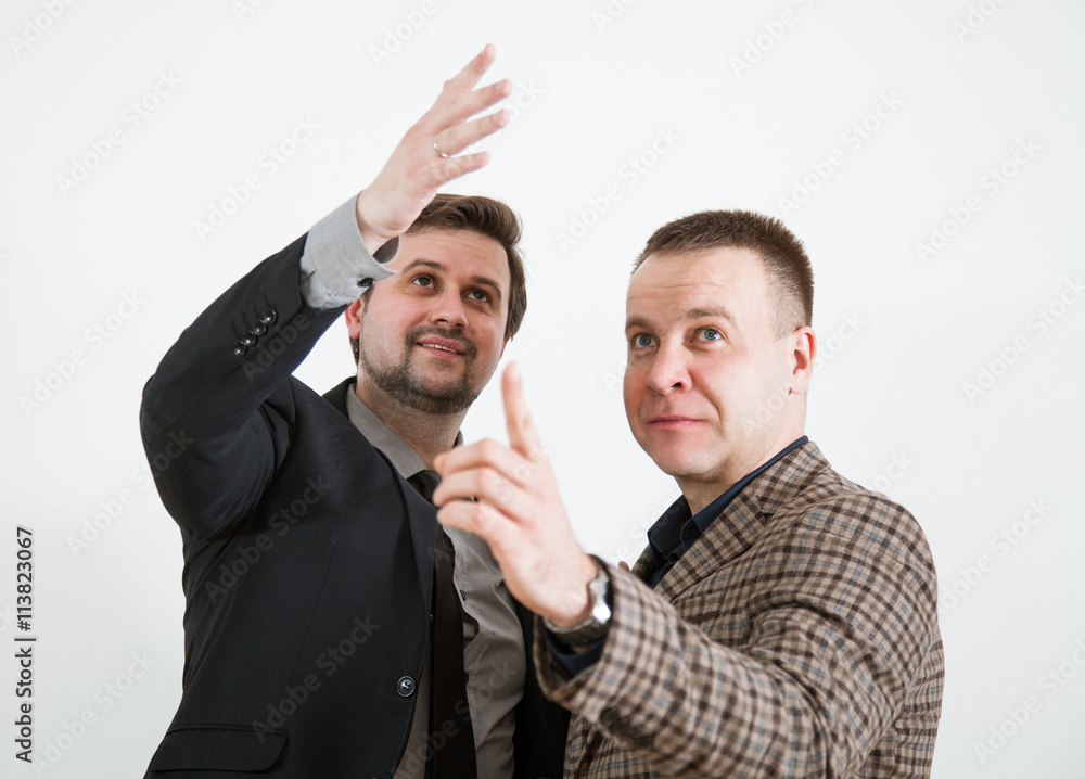 Two businessmen indicating something up Two businessmen indicating something up