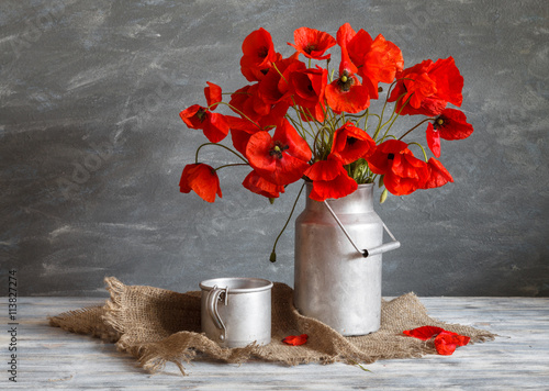 Fototapeta Naklejka Na Ścianę i Meble -  Still life in a rustic style: aluminum cookware and a bouquet of red poppies