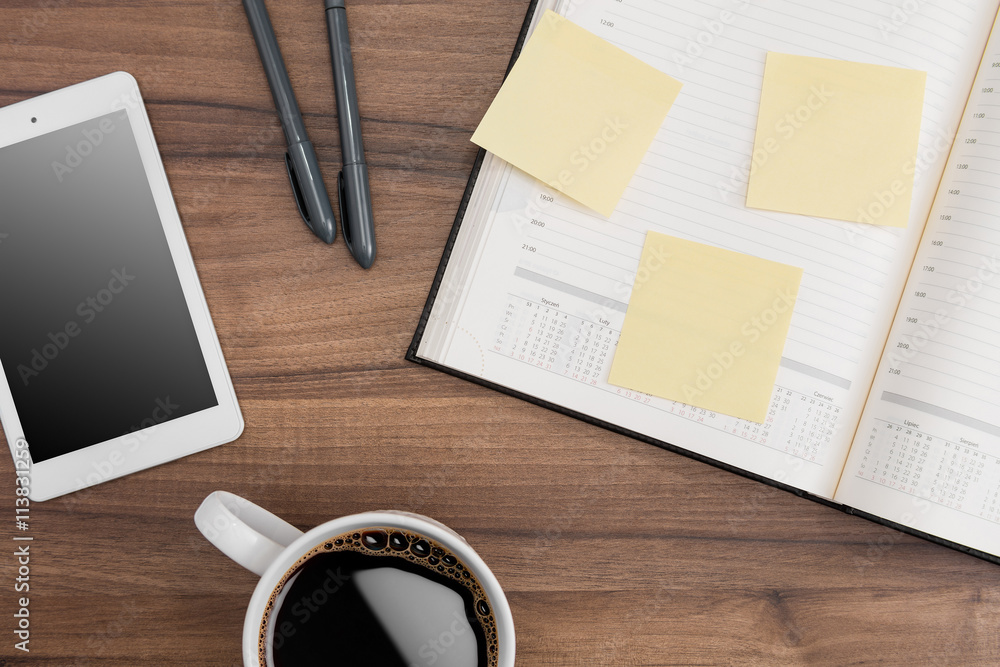 Calendar with memo notes, coffee and tablet Calendar with memo notes, coffee and tablet