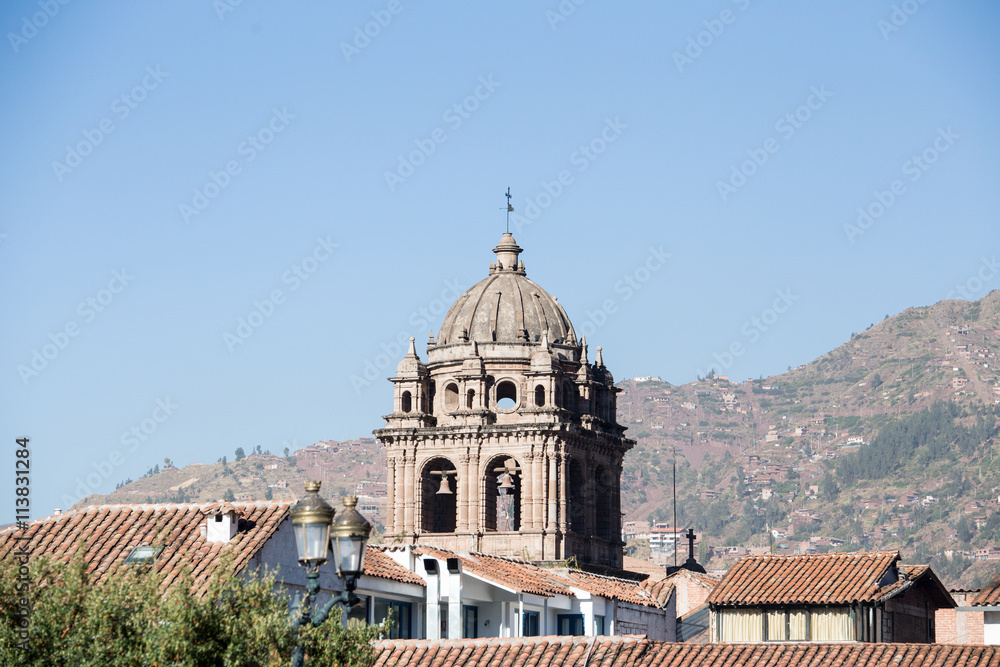 Cathedral bell tower above roofline of city