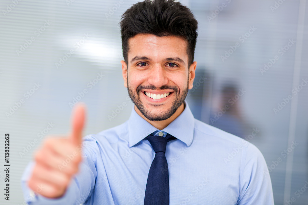 Portrait of a smiling business man giving thumbs up Portrait of a smiling business man giving thumbs up