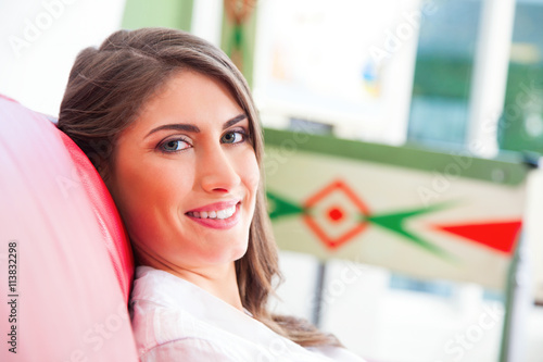 Happy young woman relaxing on sofa