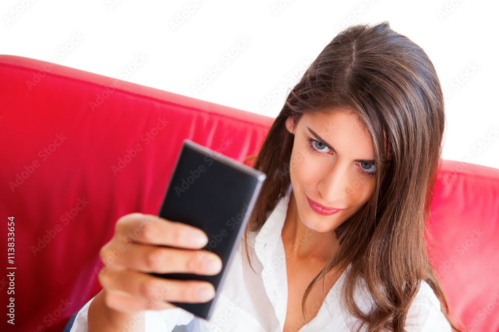 Confident woman taking selfie on sofa Confident woman taking selfie on sofa