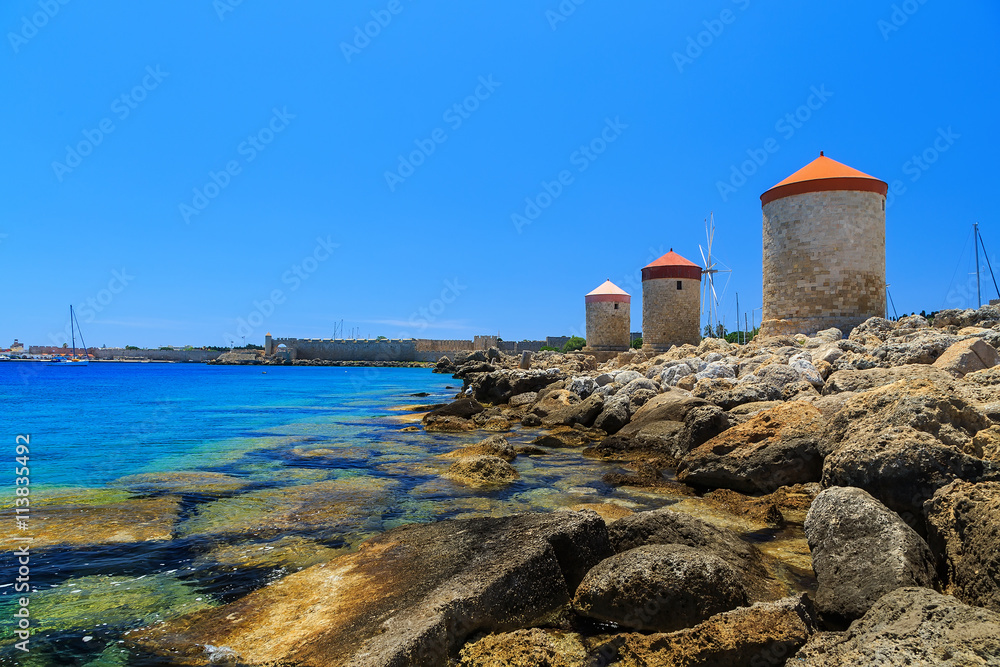 Mandraki Harbour windmills on the Island of Rhodes Greece. Sunny day