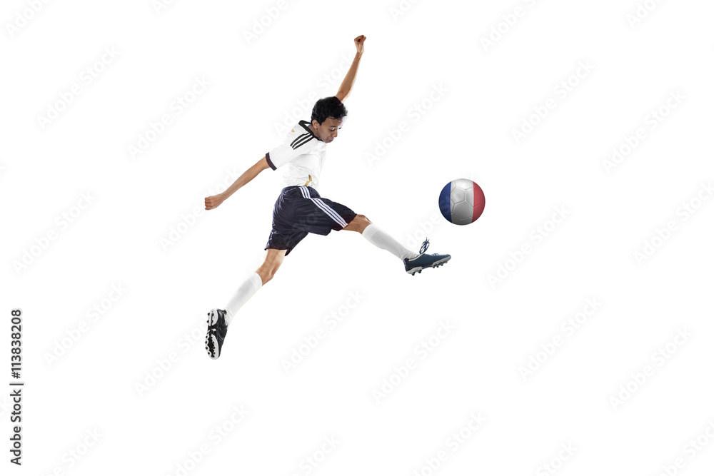 Soccer player jumping while kicking the ball Soccer player jumping while kicking the ball