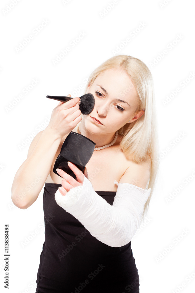 Girl with a broken arm trying to put makeup Girl with a broken arm trying to put makeup