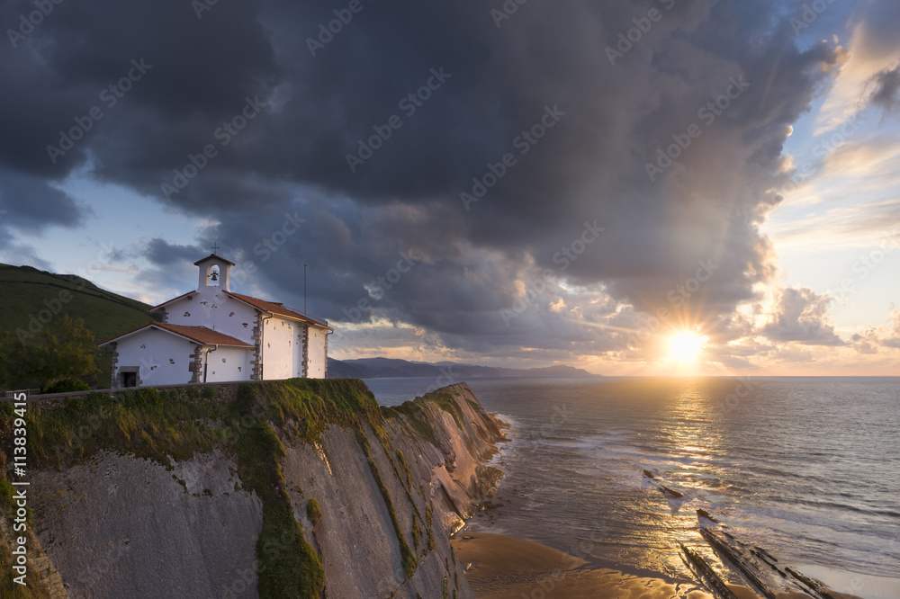San Telmo chapel and beach of Itzurun in Zumaia at sunset. Basque Country